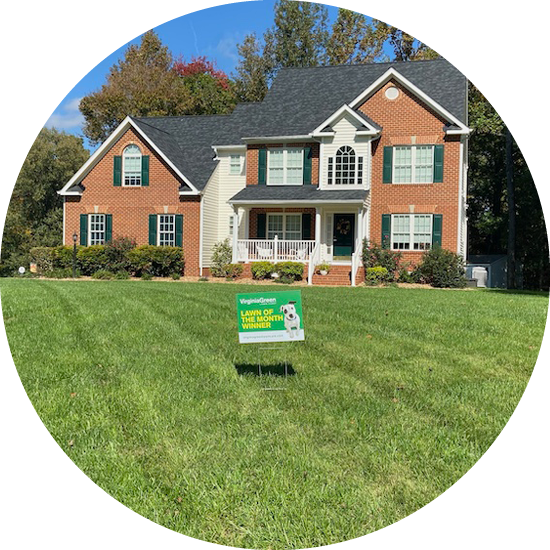 House with a Lawn of the Month sign in the front yard